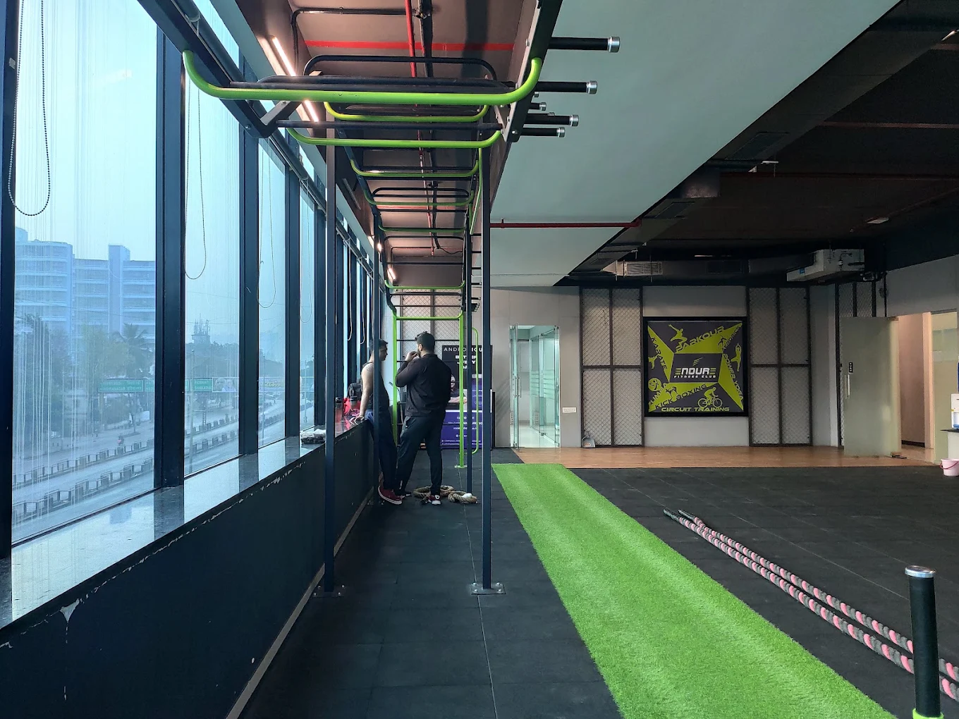 Functional training zone with green turf at Divine Fitness Club
